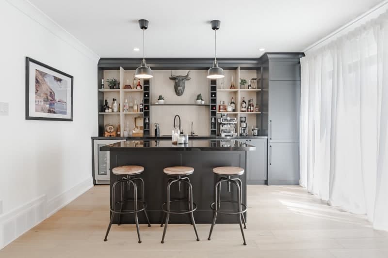 Custom home bar with integrated refrigerator and glassware storage