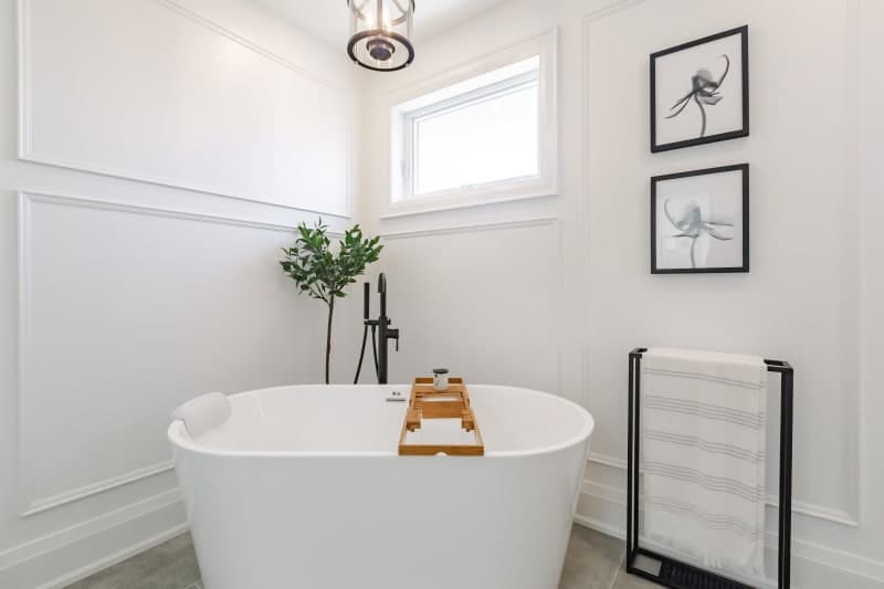 Freestanding soaker bathtub installation in renovated bathroom