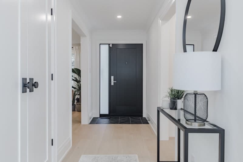 Modern hallway renovation with accent wall and pot lights