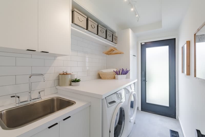 Custom laundry room renovation with built-in cabinetry and countertop