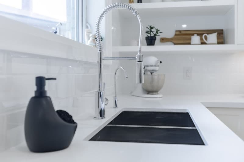 Double basin kitchen sink with designer faucet